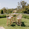 rattan bamboo high chairs and round table in a garden setting