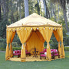 Luxury yellow octagonal shaped marquee for hire, Indian moroccan tipi bollywood in a beautiful garden setting