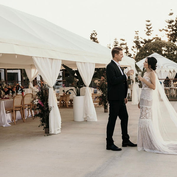 luxury white marquee with bride and groom in a slim Aarons style