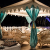 Turquoise Arabian Tents on display at night under beautiful lights with cane furniture for a corporate party