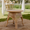 round rattan coffee table with white sofa with jute mat and floral arrangement