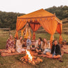 luxury yellow cabana on a farm with fire and friends celebrating 
