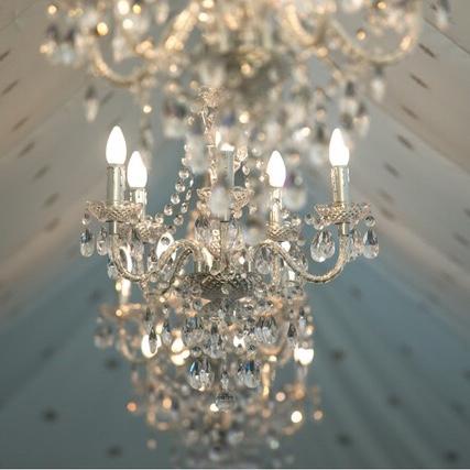 multiple chandeliers hanging from a marquee roof for hire from exotic soirees tents on the gold coast