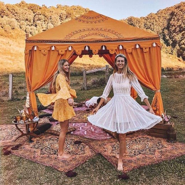 luxury yellow marquee on a farm with fire and friends celebrating