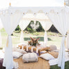 beach bohemian ladies picnic under an arabian marquee tent with grazing table, rugs and cushions which is supplied by exotic soirees hire gold coast