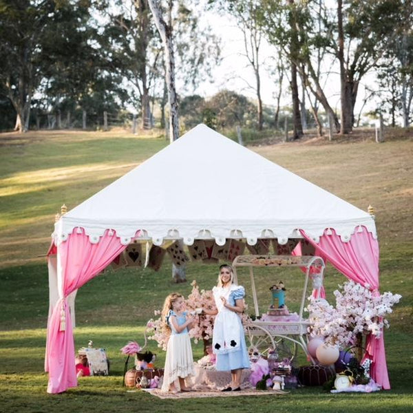 pink and white tent set up for a mad hatters luxury high tea for hire from exotic soirees marquees on the gold coast and brisbane