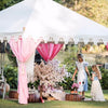 pink and white tent set up for a mad hatters luxury high tea for hire from exotic soirees marquees gold coast and brisbane