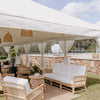 white marquee with rattan sofa lounges