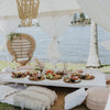 white trestle table with food and marquee