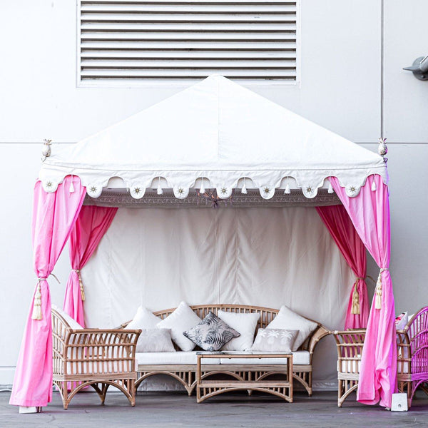 luxury pink tent or marquee with cane furniture for hire from exotic soirees on the gold coast