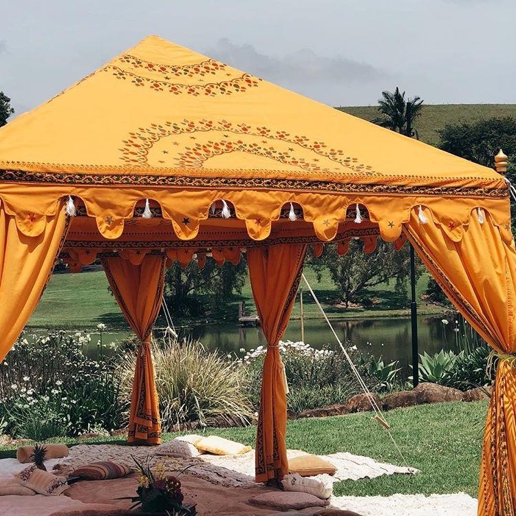 Saffron bollywood arabian marquee with styled flooring, rugs and cushions