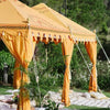 yellow arabian tent set up for a wedding full of bohemian rugs and cushions